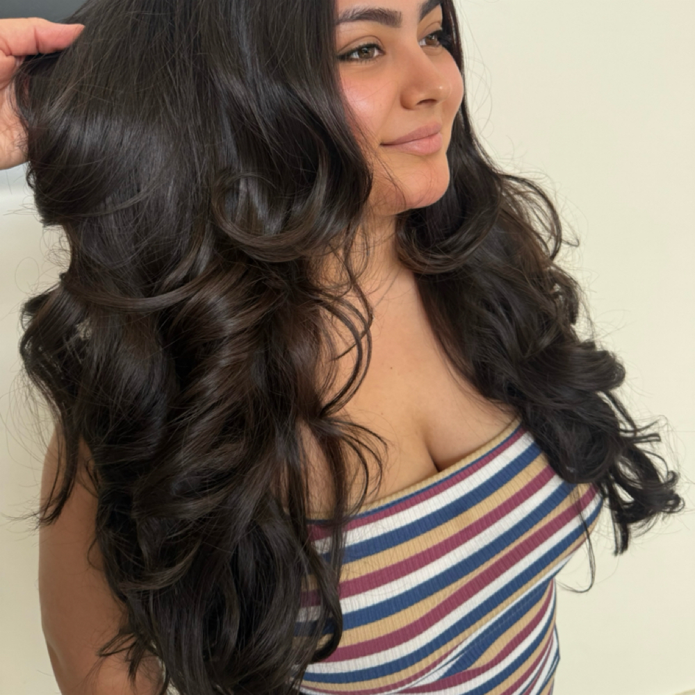 Long dark styled hair for the Signature Cut service
